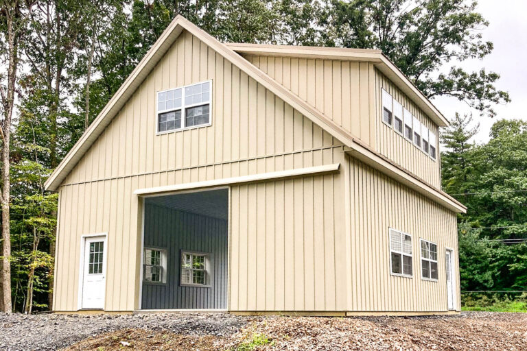 Pole Barn Permit Regulations in PA: Your Complete Guide 1 Tall tan two-story pole building with large overhead garage door.