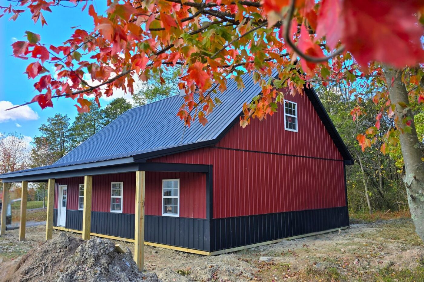Back view of 30x40 Garage in Perkiomenville PA under the autumn leaves with full view of side porch, windows, and single door