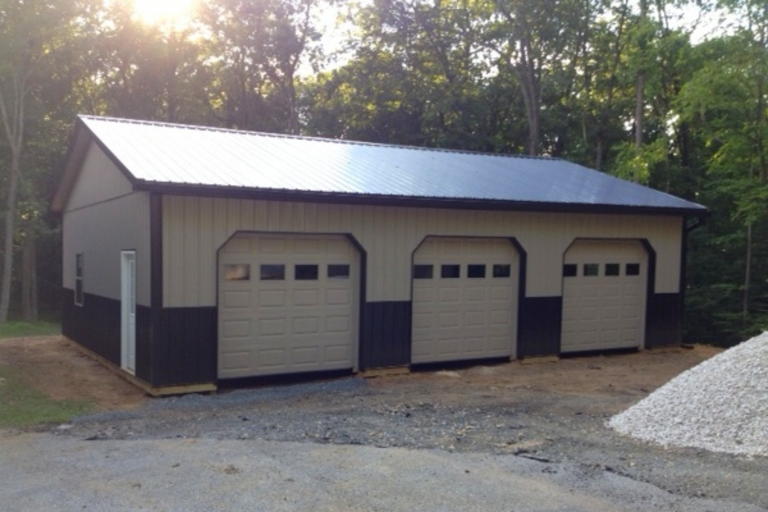 Beige and brown pole barn garage in the sun in Gilbertsville PA