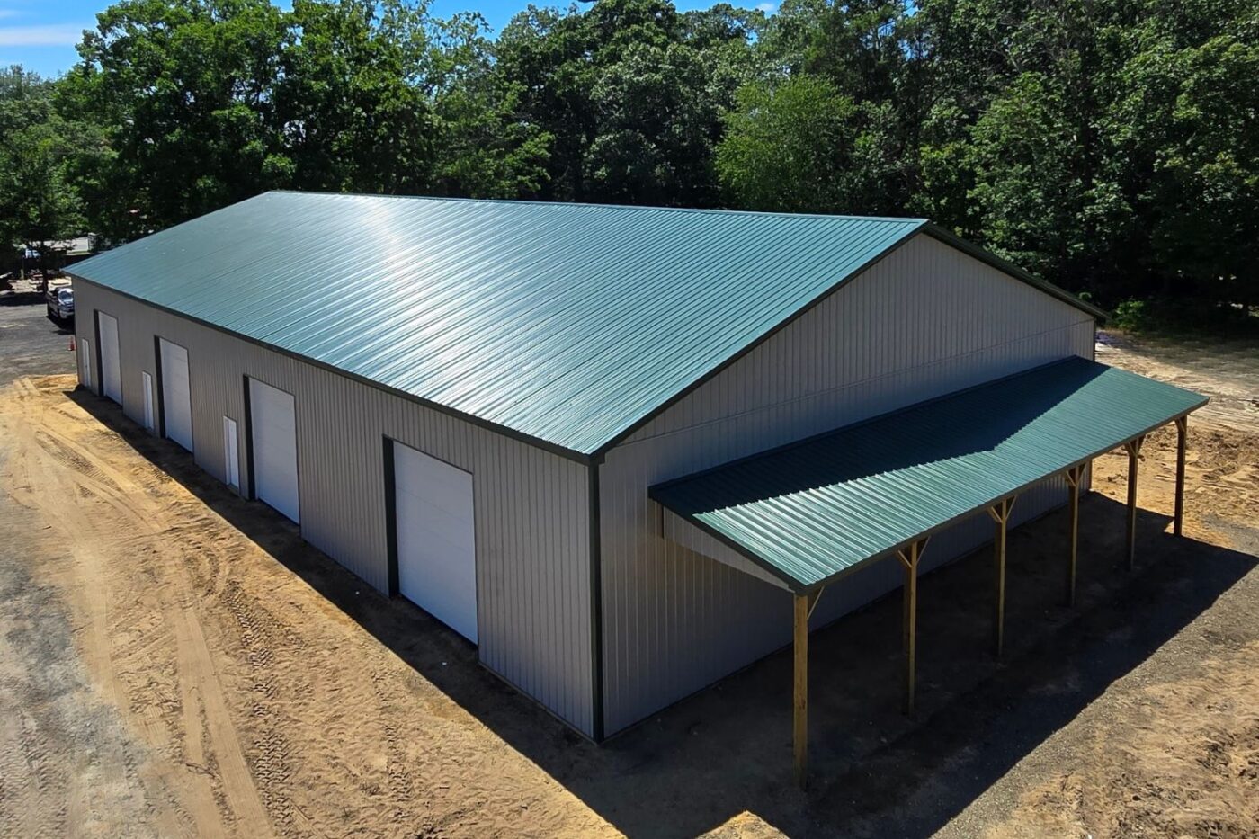 Overhead shot of a pole barn garage with overhang and white garage doors
