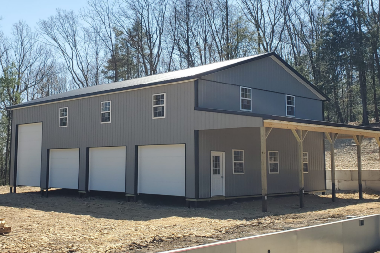 gray pole barn with three garages and windows